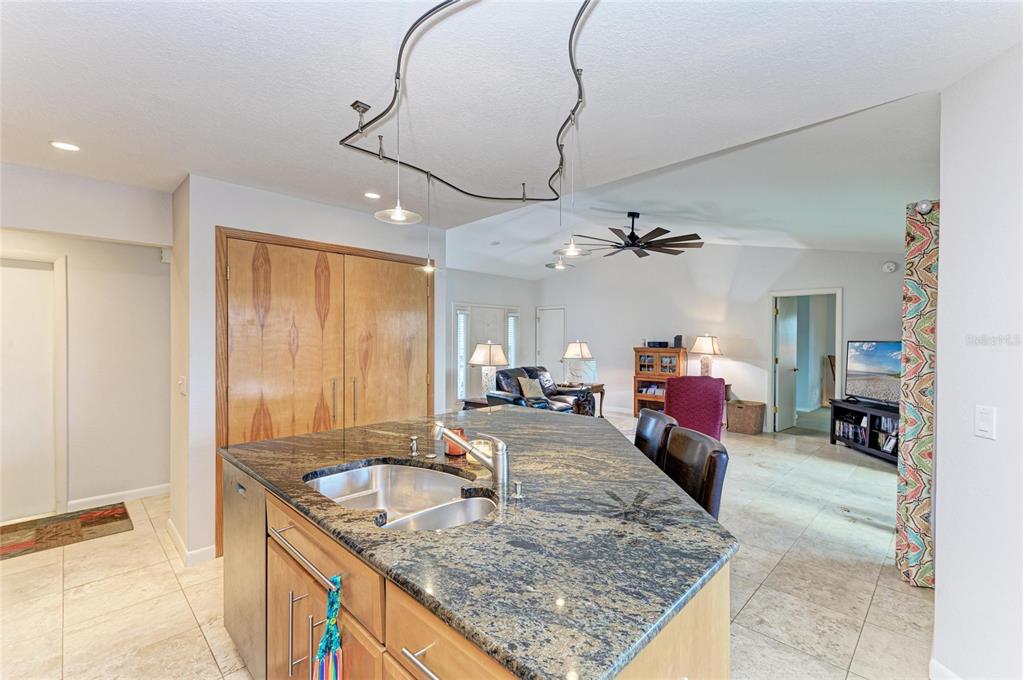258 Surinam Street Punta Gorda, FL 33983 - Photo 17 of 47 a view of a kitchen with kitchen island a counter top space a sink cabinets and appliances