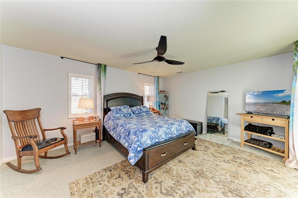 258 Surinam Street Punta Gorda, FL 33983 - Photo 20 of 47 a bedroom with a bed a chair and potted plant on the dresser