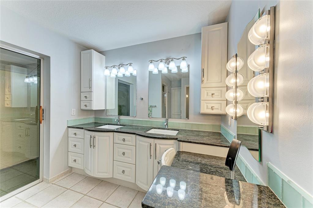 258 Surinam Street Punta Gorda, FL 33983 - Photo 23 of 47 a spacious bathroom with a granite countertop sink a mirror and a shower