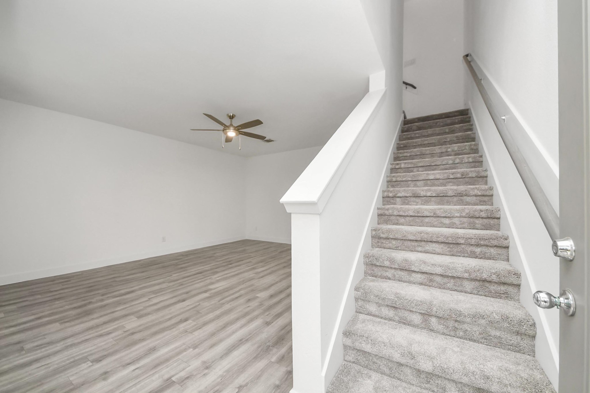 18527 Centro Row Conroe, TX 77385 - Photo 9 of 44 Plush carpeting guides the way up the staircase, transitioning the home from the active entry to the refined social quarters.