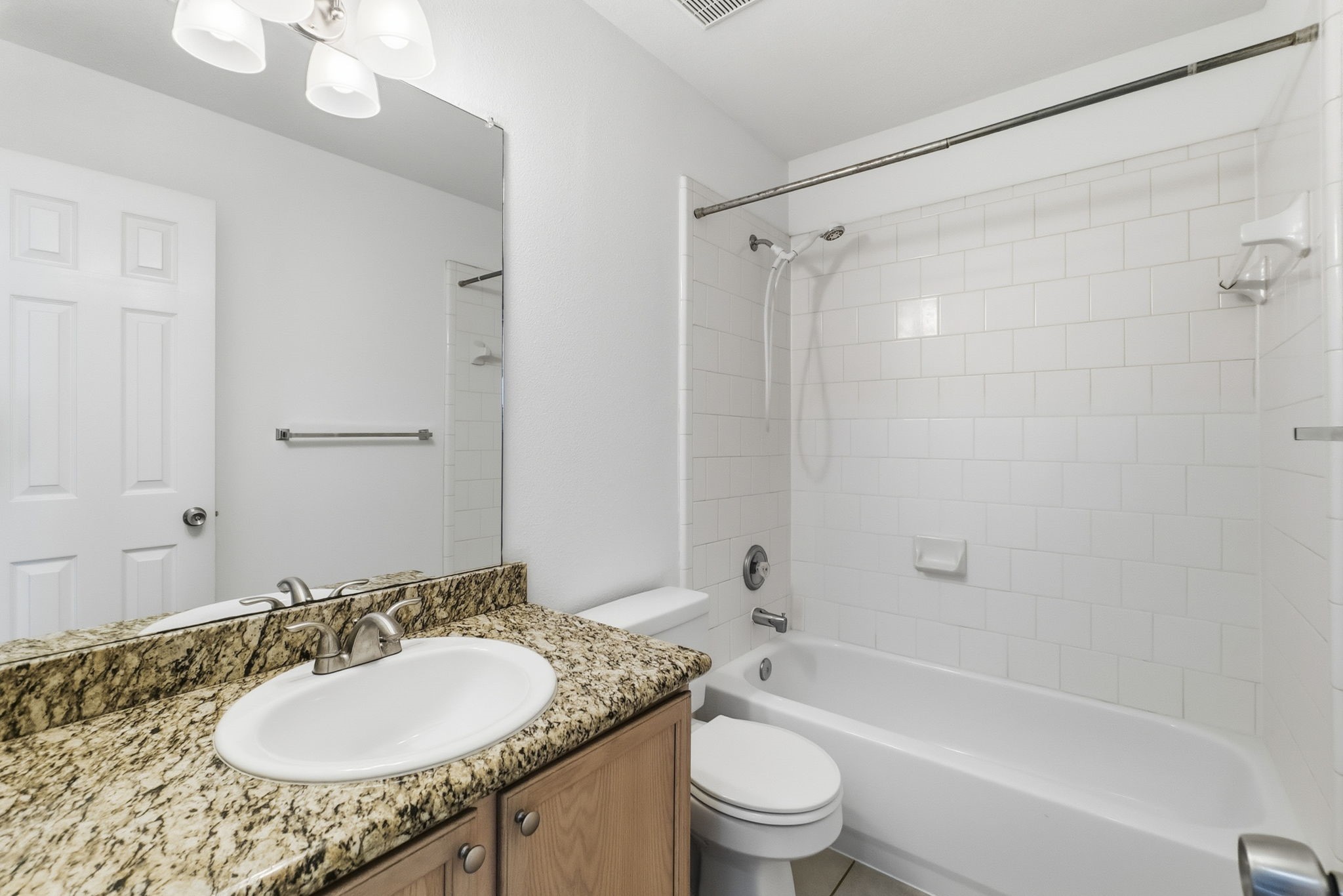 11907 Ezekiel Road Tomball, TX 77375 - Photo 33 of 39 a bathroom with a granite countertop sink toilet mirror and shower