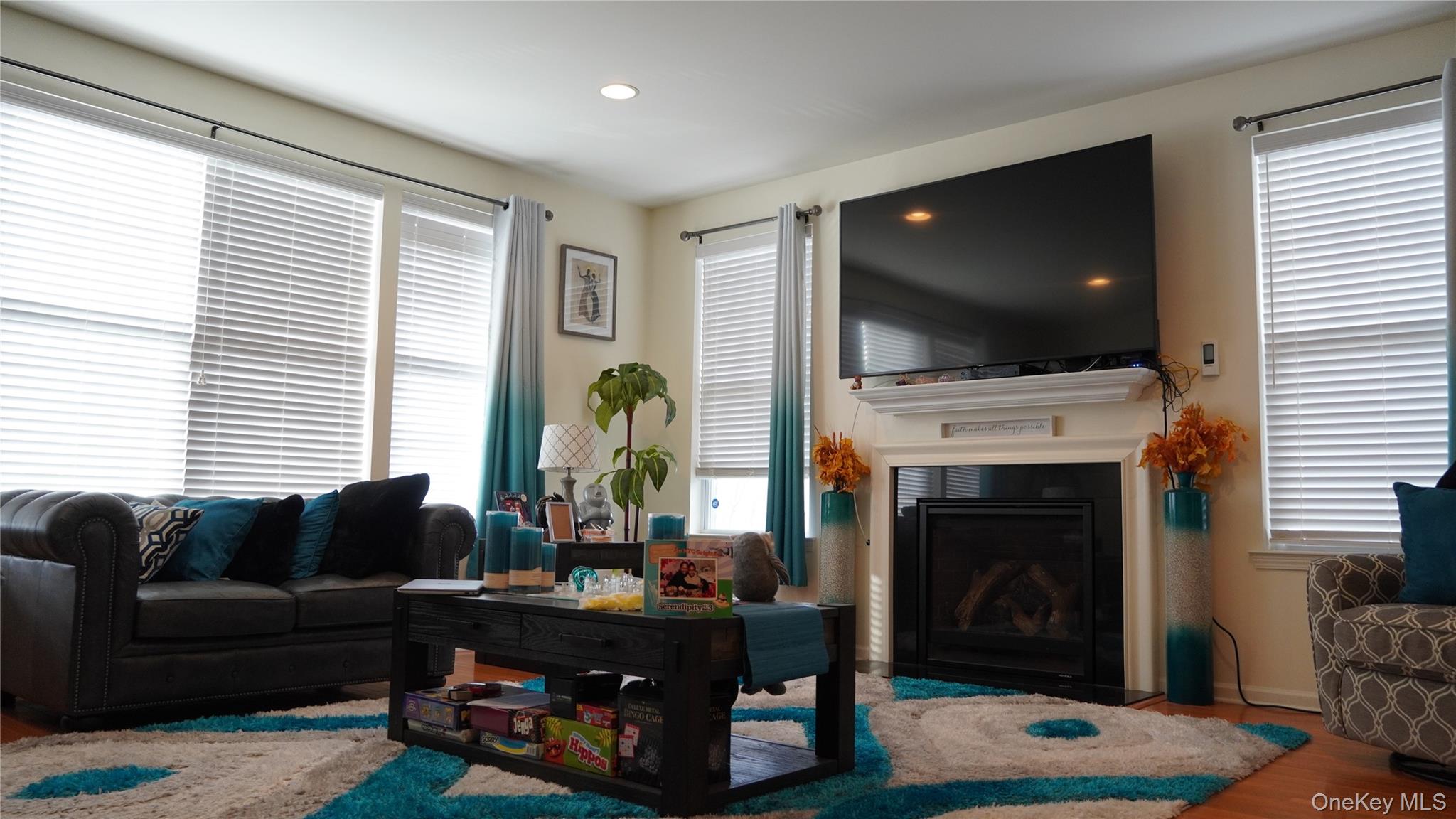 1402 Hawthorn Way New Windsor, NY 12553 - Photo 5 of 25 a living room with furniture a flat screen tv and a fireplace