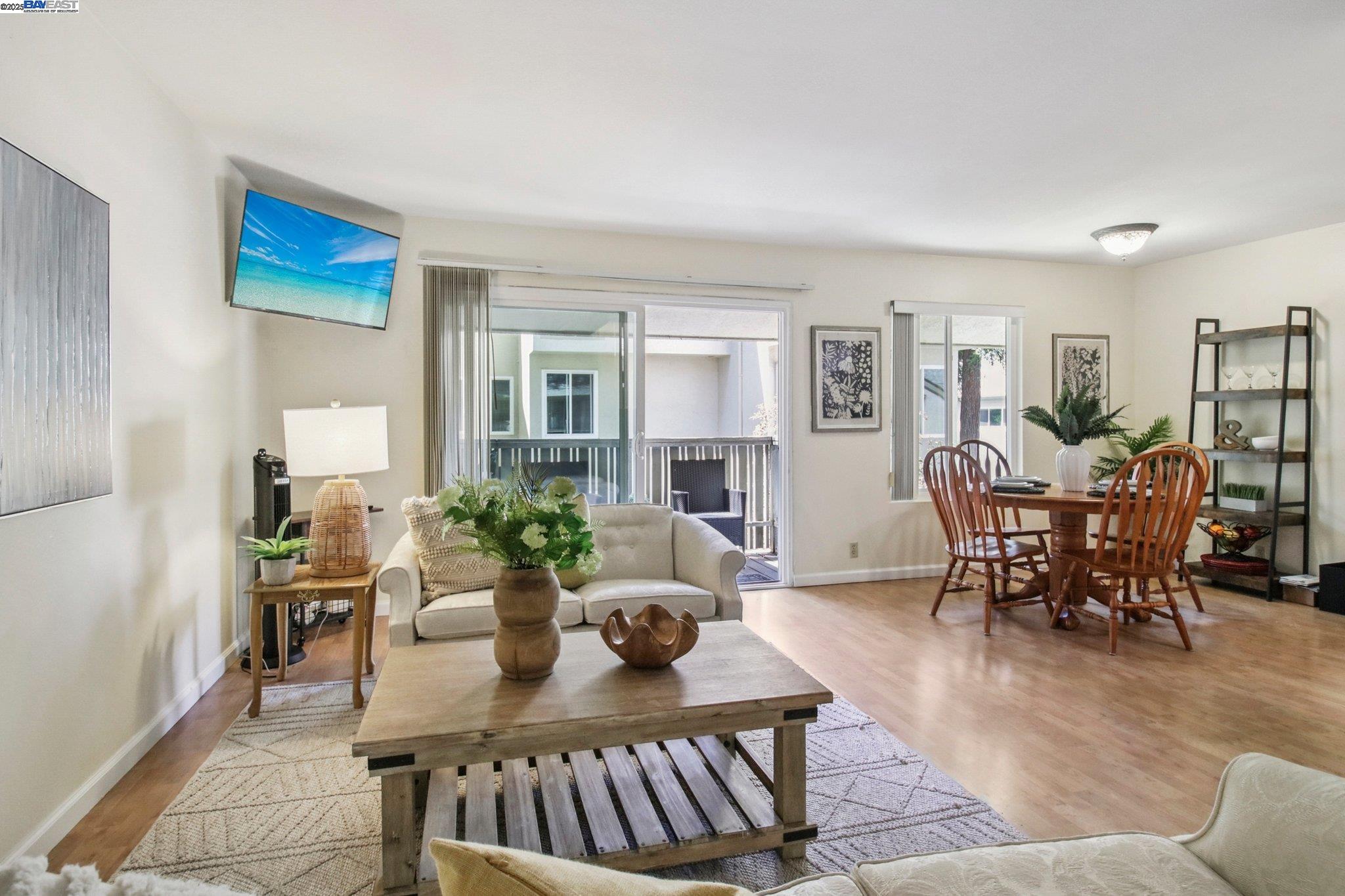 2716 Oak Road, Unit 117 Walnut Creek, CA 94597 - Photo 1 of 1 a living room with furniture a dining table and a potted plant