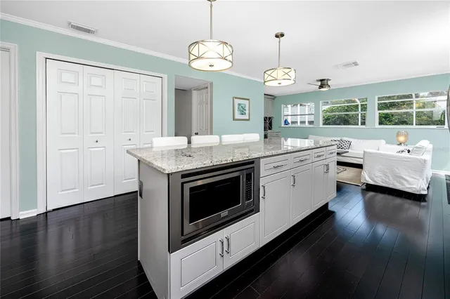 a living room with furniture and kitchen view