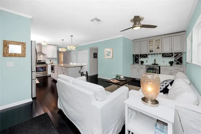 a view of a dining room with furniture a chandelier and wooden floor