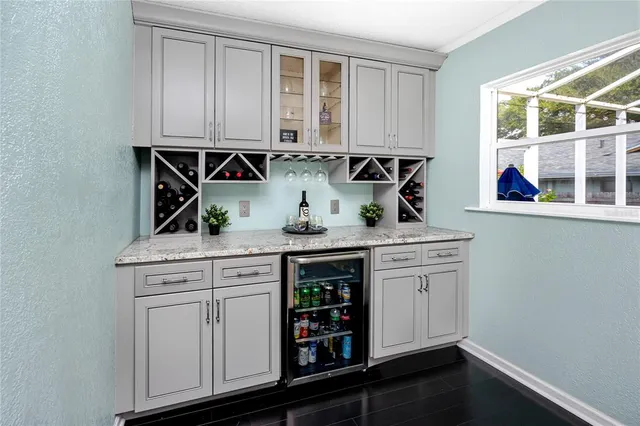 a utility room with granite countertop a sink and a washer dryer