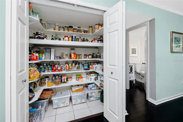 a view of a work space with wooden floor and a window