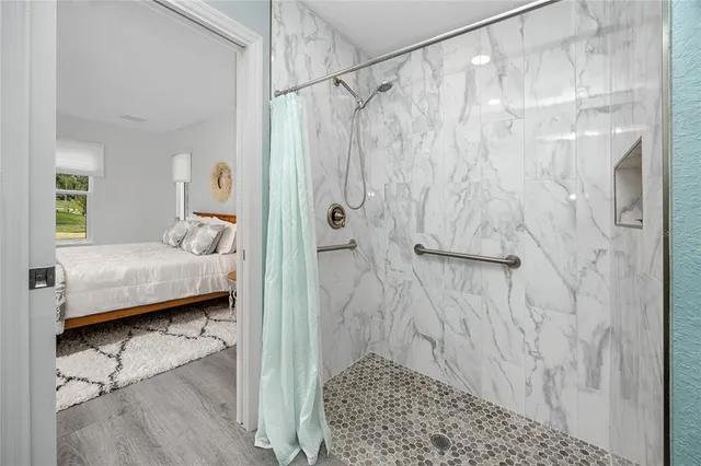 a bathroom with a double vanity sink toilet mirror and shower