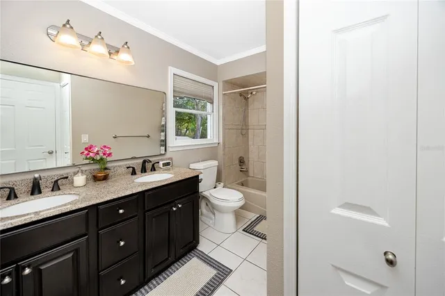 an aerial view of a house with swimming pool and large trees