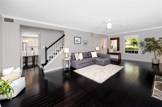 a living room with furniture fireplace and potted plant