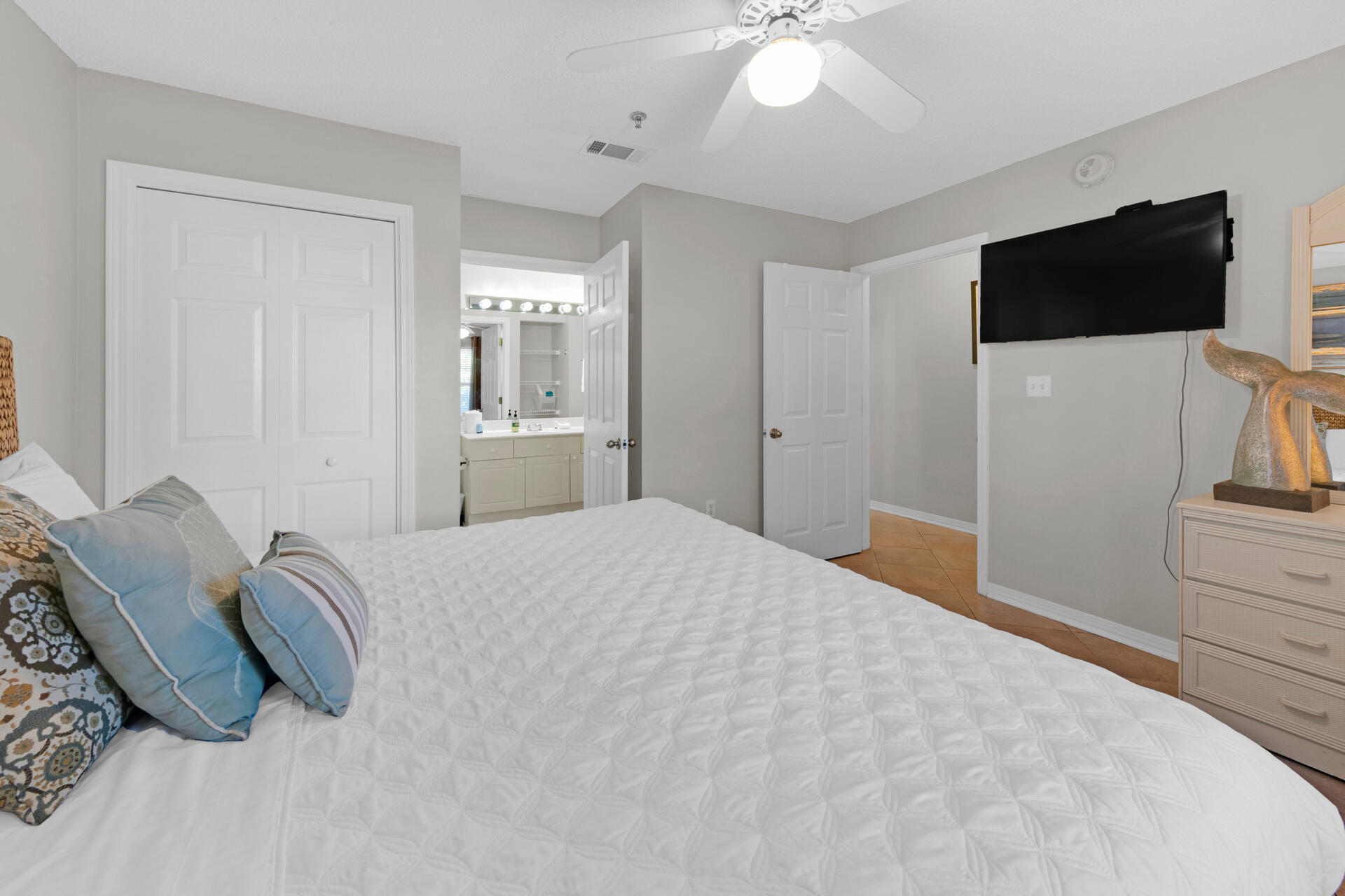 144 Spires Lane, Unit 110 Santa Rosa Beach, FL 32459 - Photo 16 of 33 a spacious bedroom with a bed and a flat screen tv