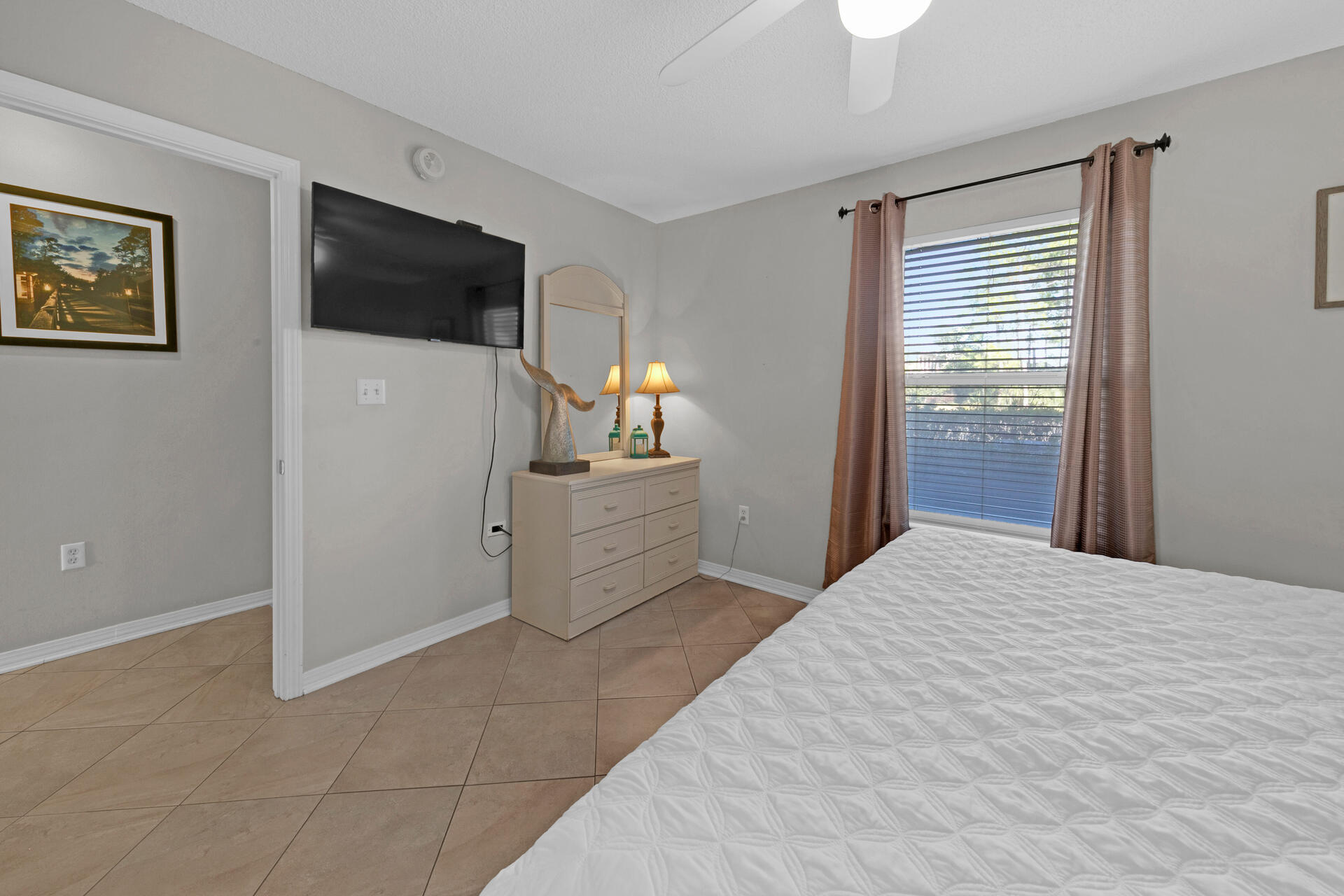144 Spires Lane, Unit 110 Santa Rosa Beach, FL 32459 - Photo 17 of 33 a bedroom with a bed and a flat screen tv