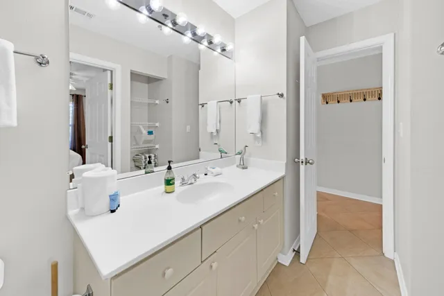 a en suite bathroom with double sink and a mirror