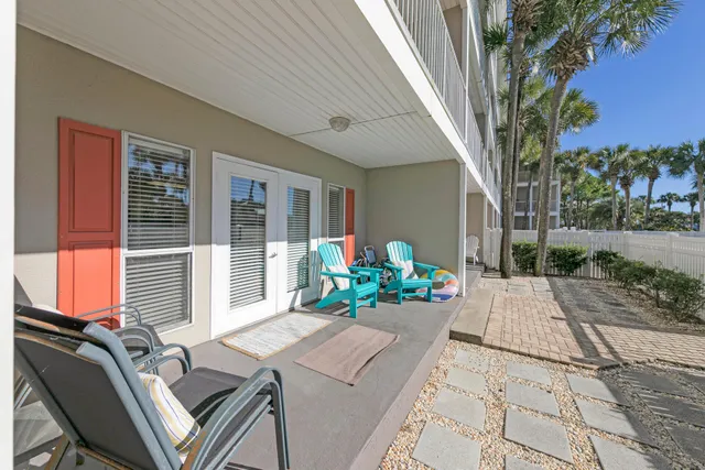a view of a patio with table and chairs and potted plants