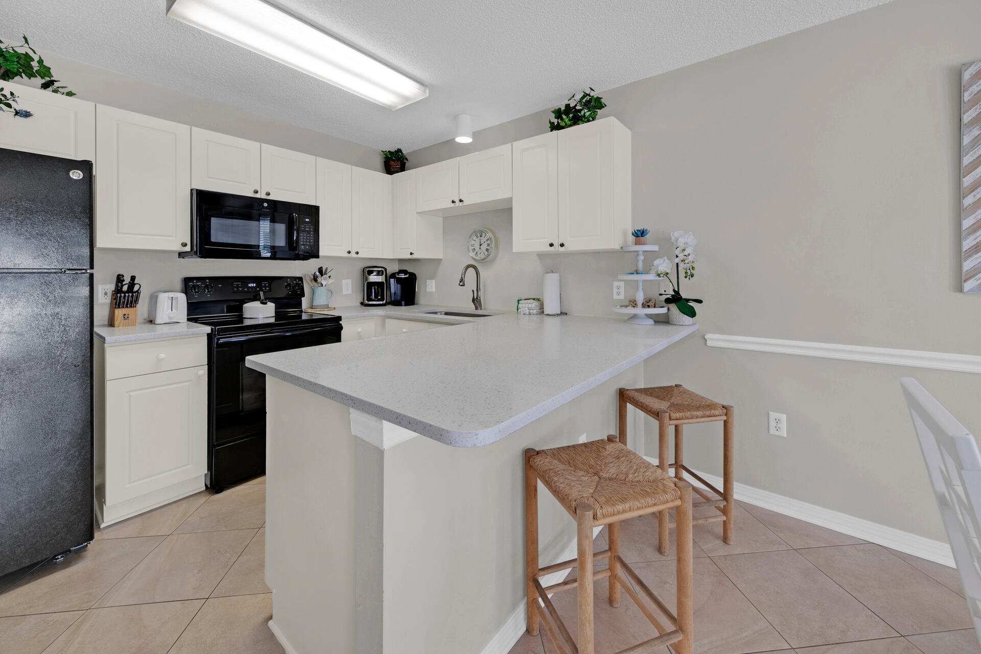 144 Spires Lane, Unit 110 Santa Rosa Beach, FL 32459 - Photo 8 of 33 a kitchen with a sink a microwave and refrigerator