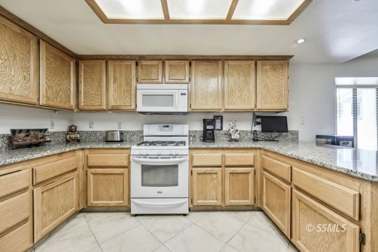 1260 Arroyo Street Ridgecrest, CA 93555 - Photo 5 of 44 a kitchen with cabinets appliances a sink and a window