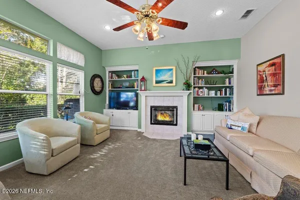 a bedroom with a bed a chandelier and dresser
