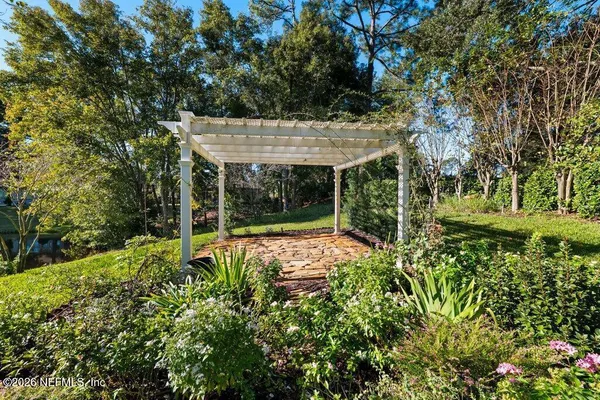 a view of backyard with table and chairs and potted plants