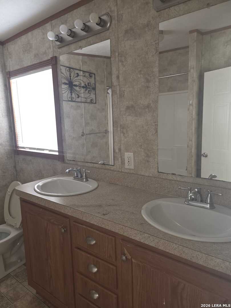 311 East Frio Street Dilley, TX 78017 - Photo 12 of 24 a bathroom with a sink and a mirror