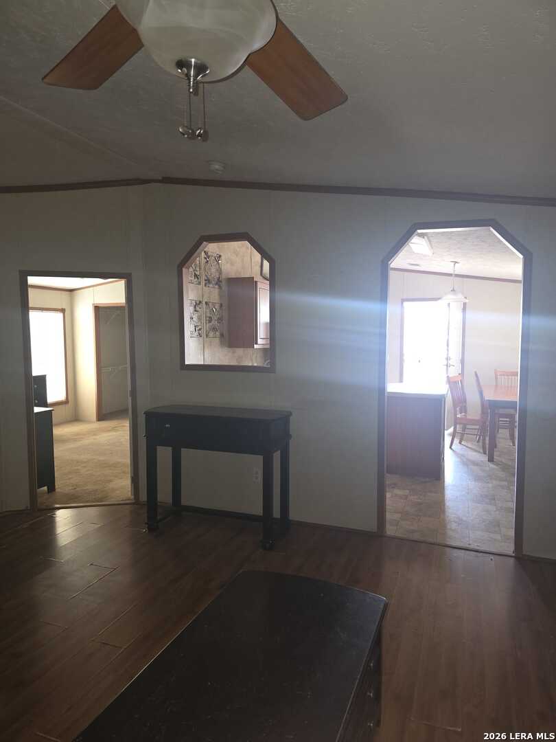 311 East Frio Street Dilley, TX 78017 - Photo 15 of 24 an empty room with wooden floor and windows