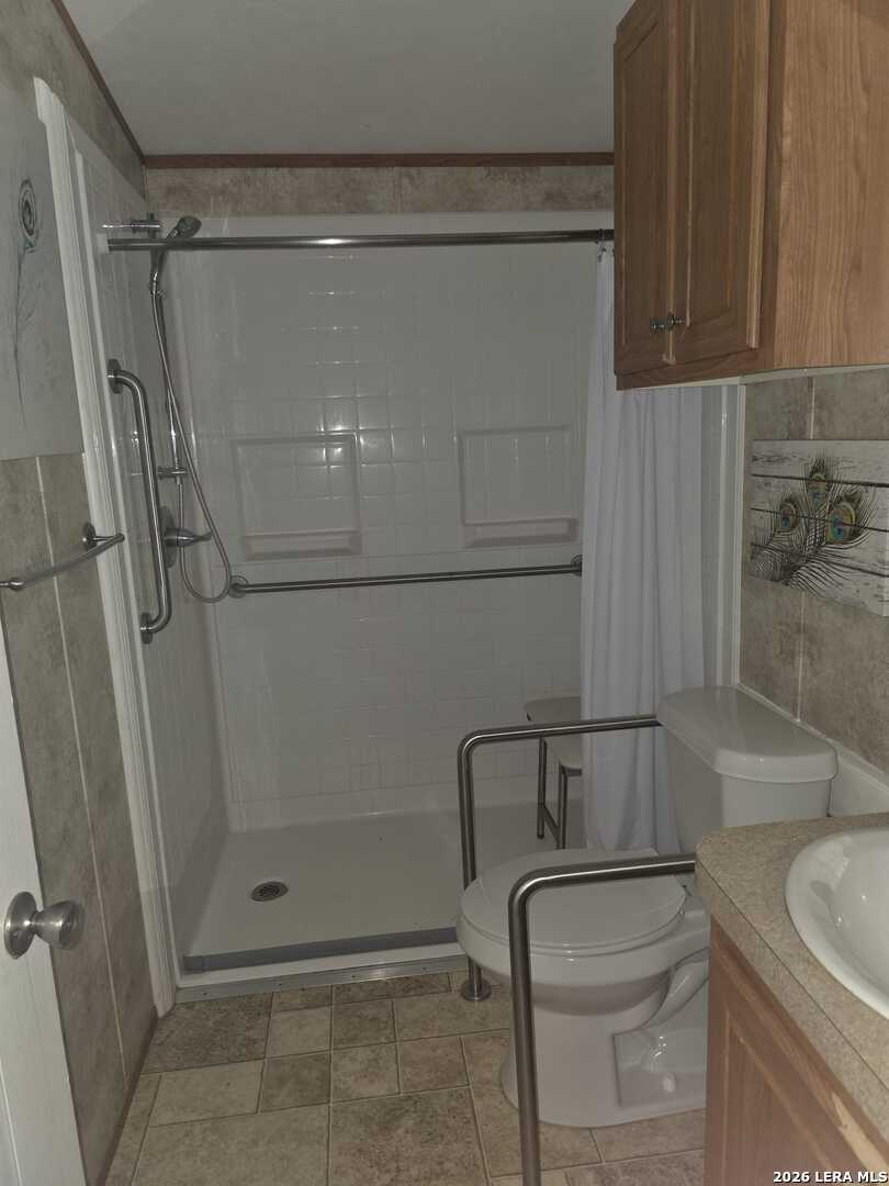 311 East Frio Street Dilley, TX 78017 - Photo 16 of 24 a bathroom with a shower and a sink