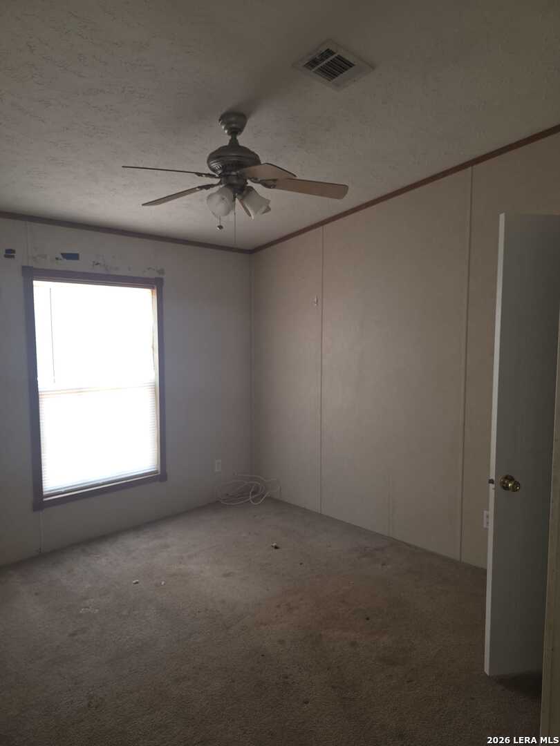 311 East Frio Street Dilley, TX 78017 - Photo 20 of 24 a view of an empty room with a window