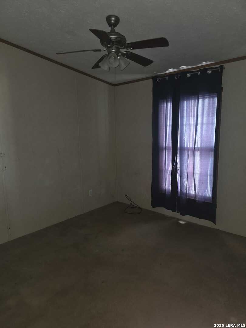 311 East Frio Street Dilley, TX 78017 - Photo 21 of 24 wooden floor and window in an empty room