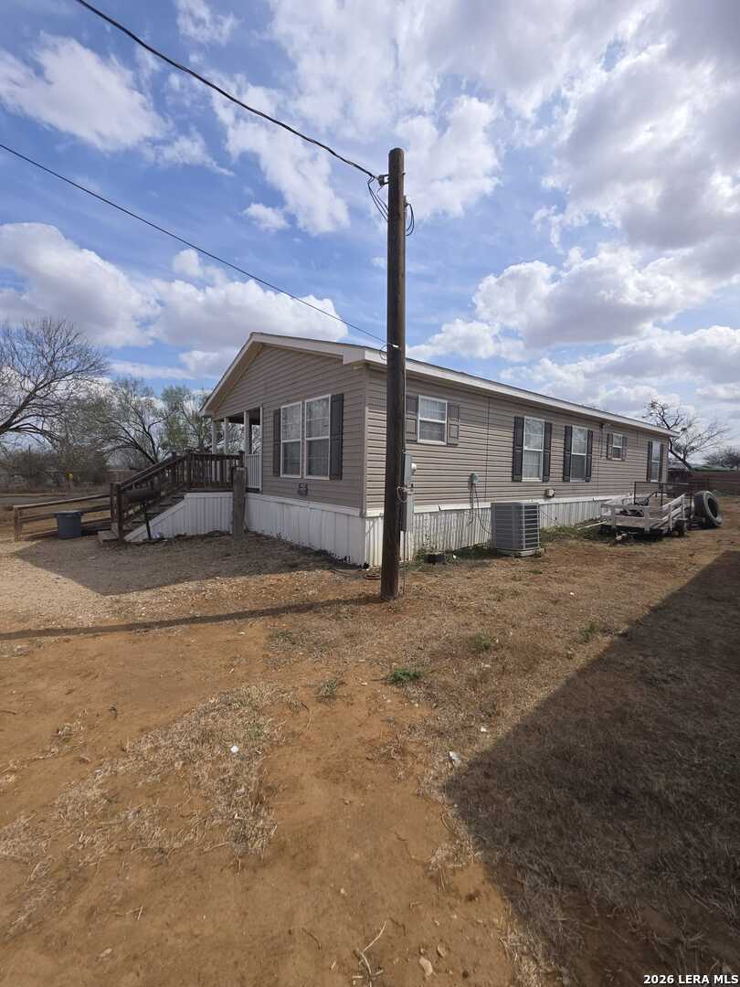 311 East Frio Street Dilley, TX 78017 - Photo 3 of 24 a view of a house with a yard