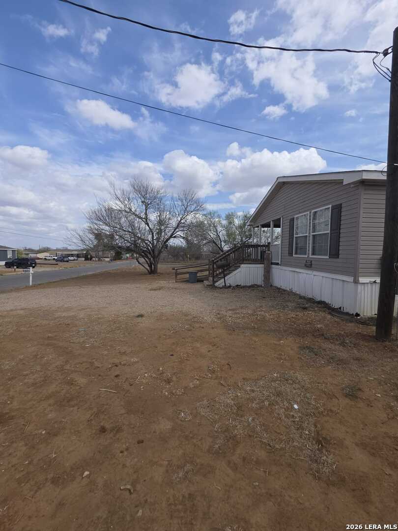 311 East Frio Street Dilley, TX 78017 - Photo 4 of 24 a view of a house with a yard