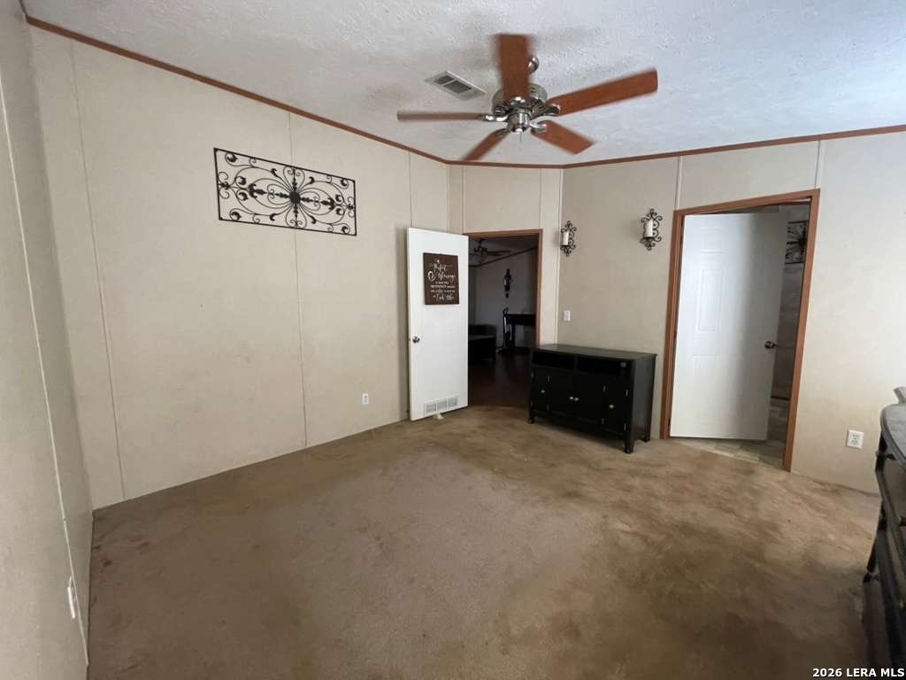 311 East Frio Street Dilley, TX 78017 - Photo 9 of 24 a view of a livingroom with a ceiling fan