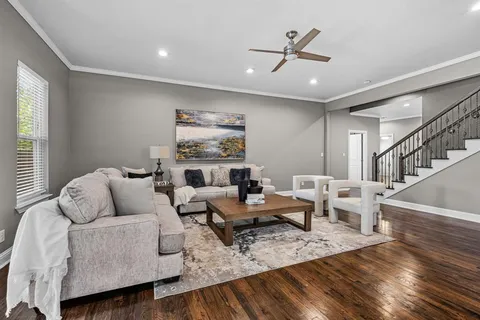 a living room with furniture and a wooden floor