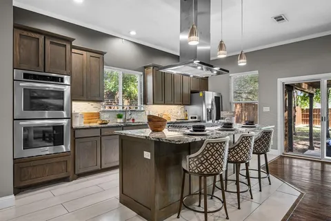 a kitchen with a dining table and chairs