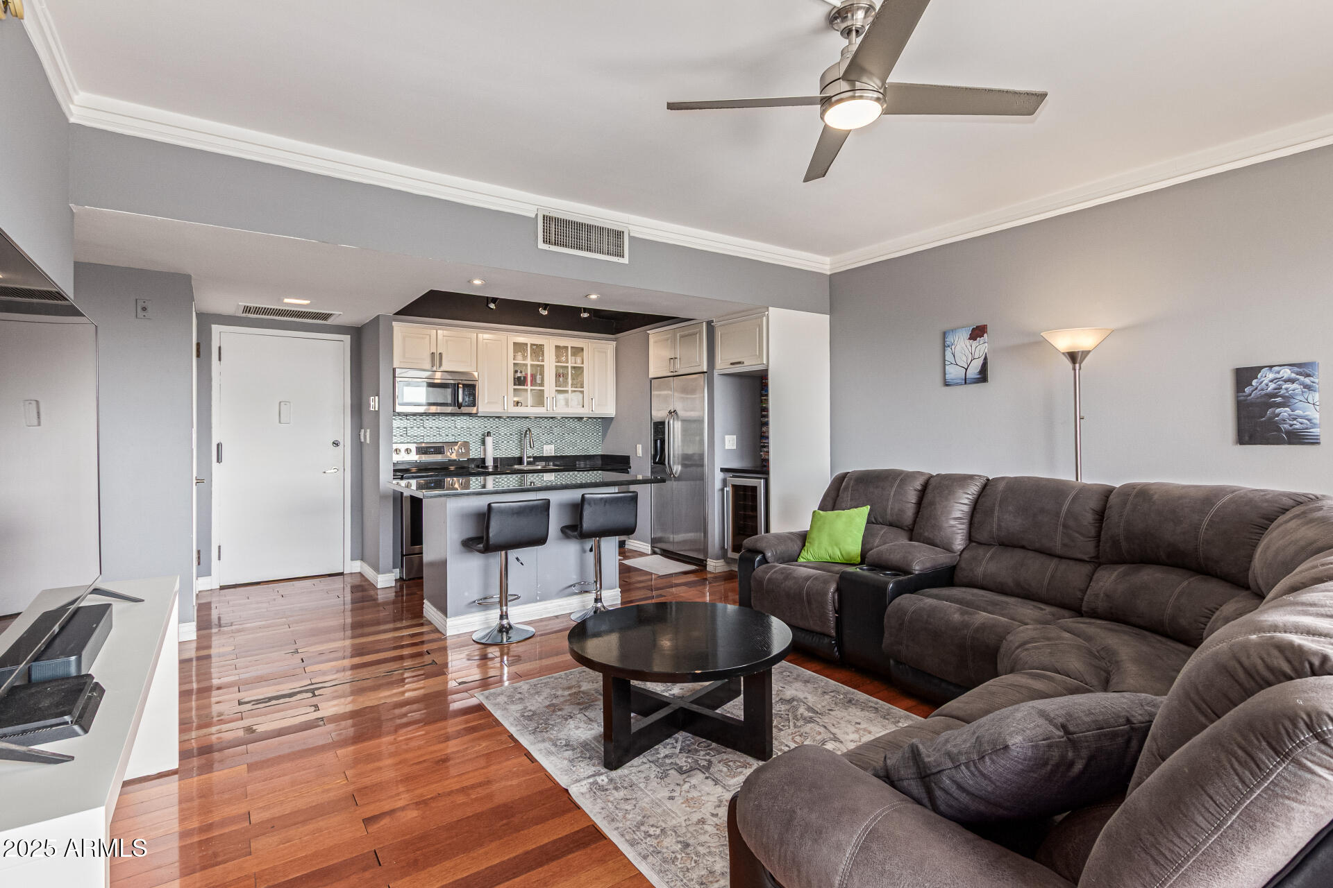 a living room with furniture and kitchen view