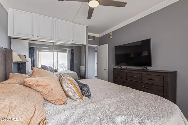 a bedroom with a bed and a flat screen tv