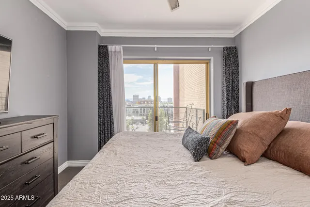 a large bed sitting in a bedroom next to a window