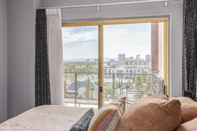 a bedroom with a bed and a large window