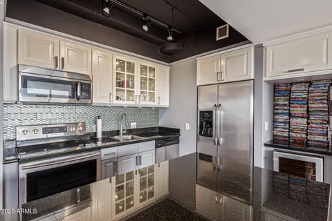 a kitchen with stainless steel appliances granite countertop a stove and a refrigerator