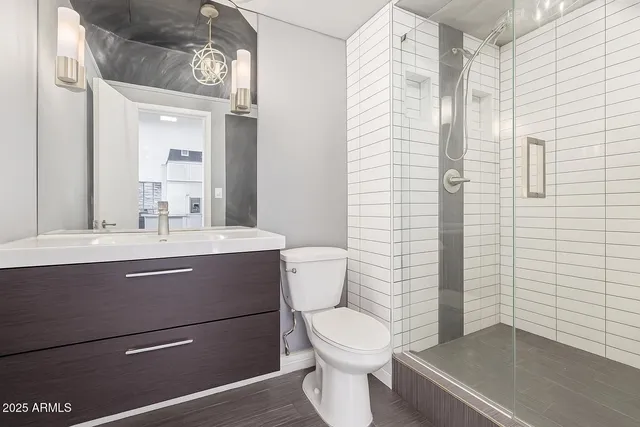 a bathroom with a toilet a sink and shower