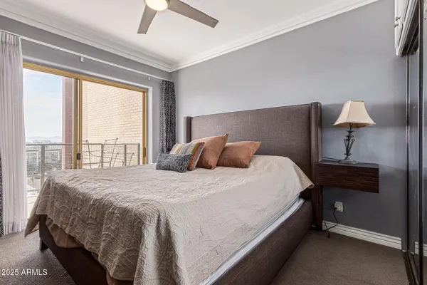 a bed sitting in a bedroom next to a window