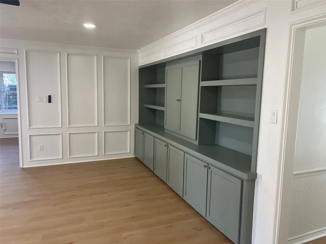a view of an empty room with a kitchen