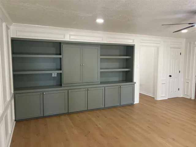 a room with cabinet and white cabinet