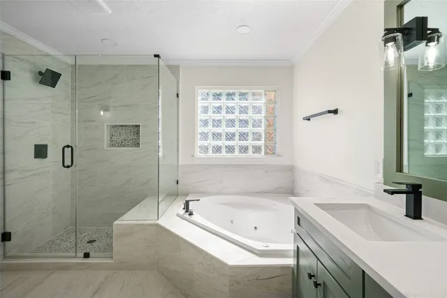 a bathroom with a tub sink and a shower