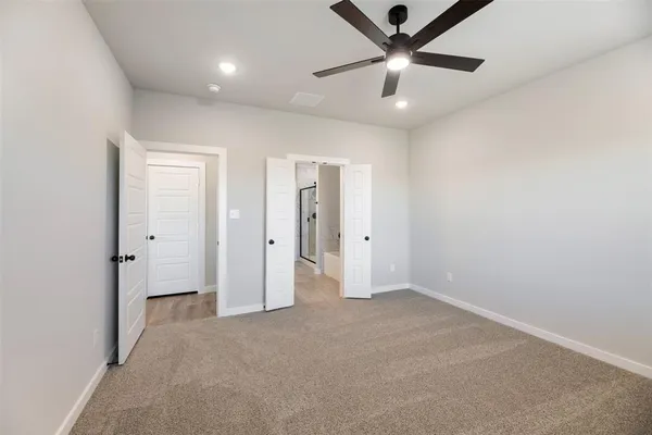 a view of an empty room and a ceiling fan