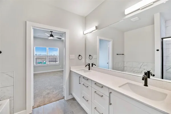 a bathroom with a double vanity sink mirror and