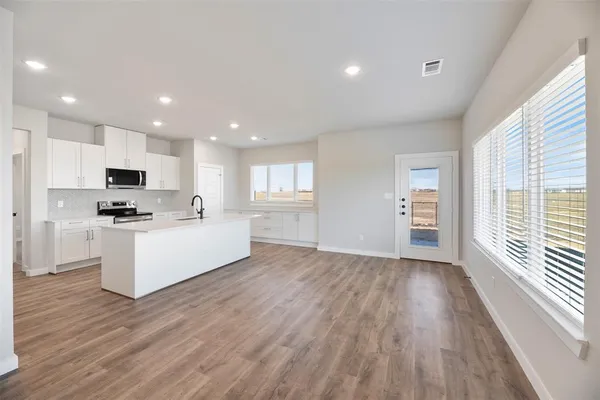 a view of kitchen with sink and wooden floor