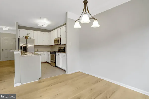 a view of a kitchen with microwave and cabinets