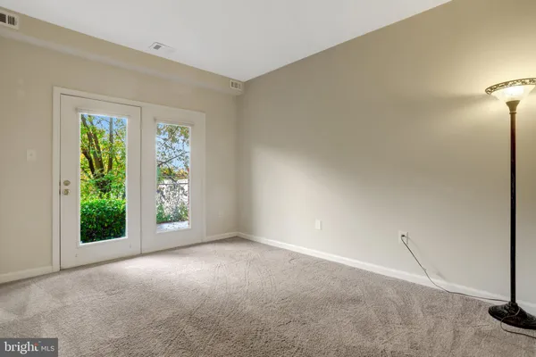 a view of an empty room and closet area
