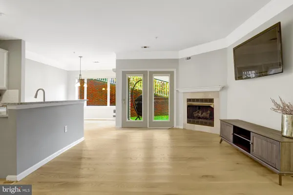 a view of an empty room with a fireplace and a flat screen tv
