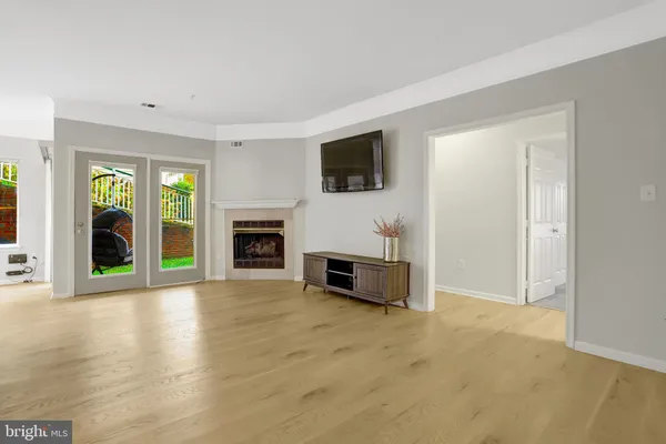 a view of a livingroom with an empty space and a fireplace
