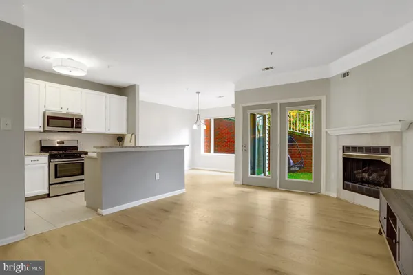 a view of a kitchen with a sink stove cabinets and empty room
